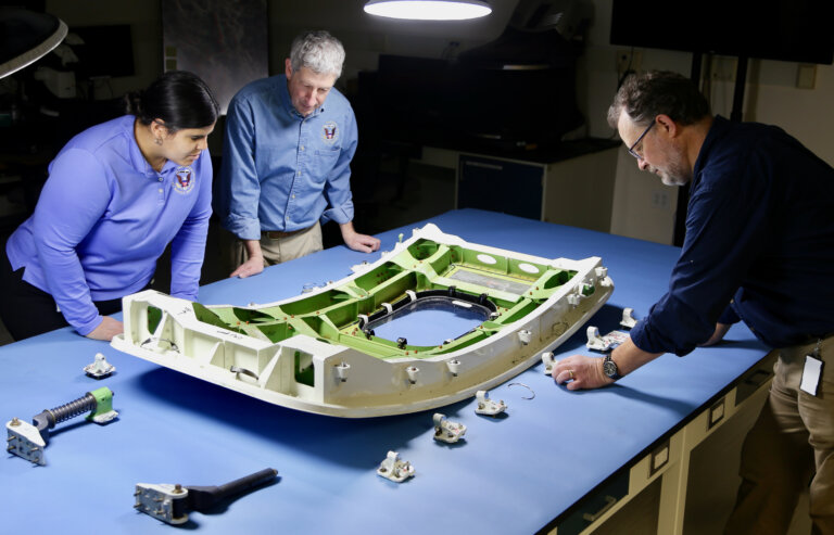 ​NTSB investigators examine the door plug from Alaska Airlines flight 1282, a Boeing 737-9 MAX.​