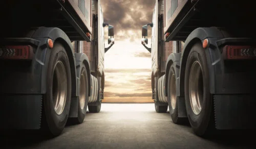 Semi TrailerTrucks on Parking with The Sunset Sky. Shipping Container Truck. Delivery Transit. Engine Diesel Truck Tractor. Industry Freight Trucks Logistics Cargo Transport.